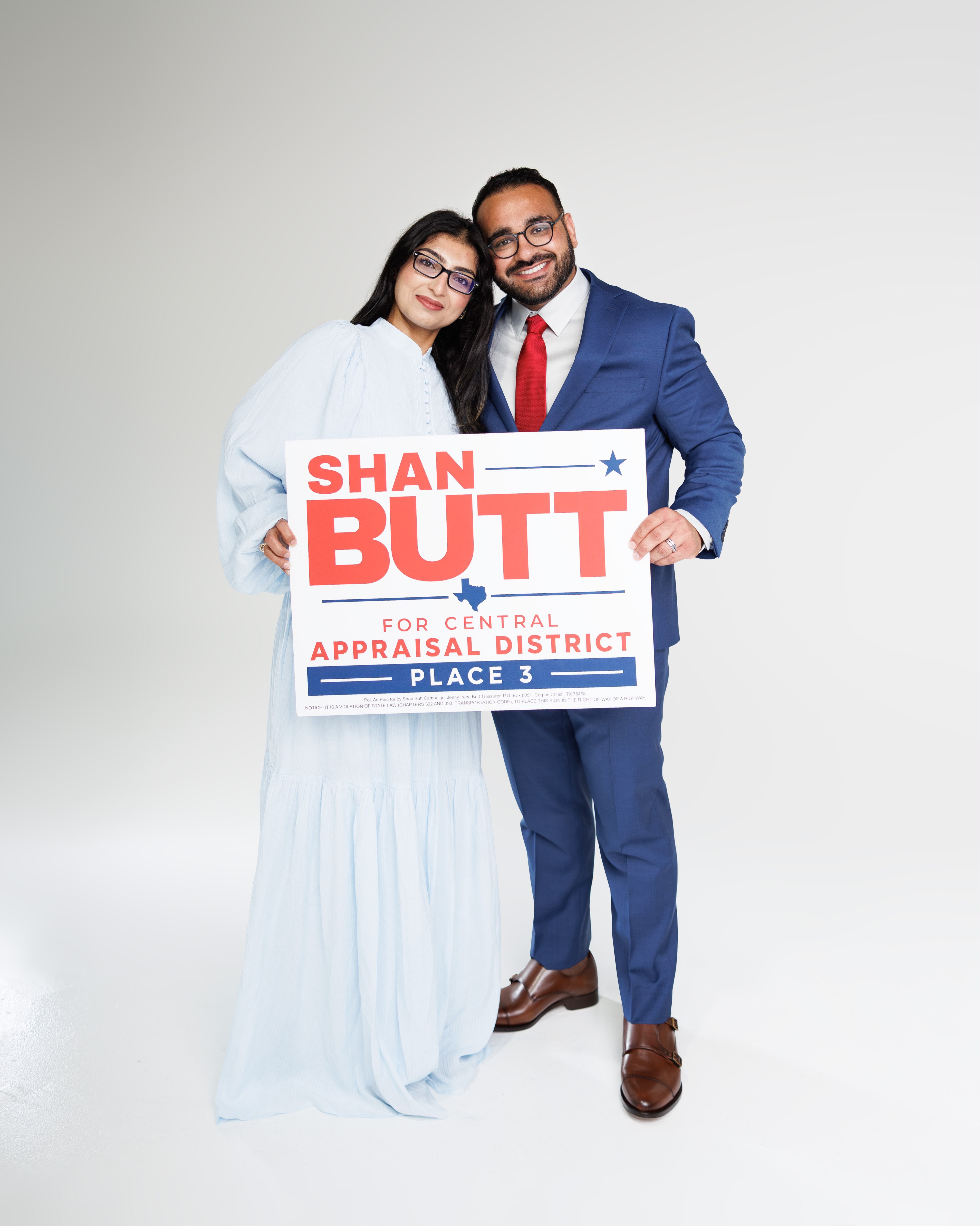 Shan and his wife holding his Place 3 campaign sign